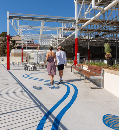 Couple walking on the terrace of the Torpedo Factory Precinct at Sub Base Platypus.