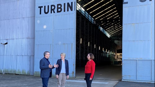 The Hon. Tanya Plibersek MP, Joseph Carrozzi AM and Janet Carding outside Cockatoo Island’s Turbine Shop.